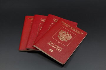 Four passports on a dark background