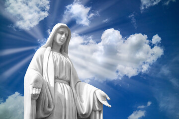 Fototapeta premium Mary statue on white clouds with light ray at heaven. religion,.