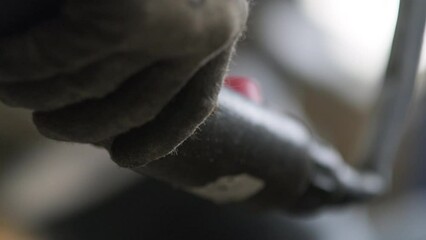 Closeup Of Worker Operating Lifting Crane With Controller, Gloves Covering Hands - Powered by Adobe