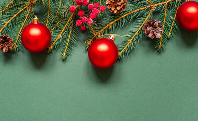 christmas background - pine tree branches, presents and decor on green copy space