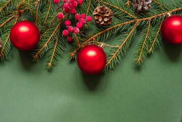 christmas background - pine tree branches, presents and decor on green copy space