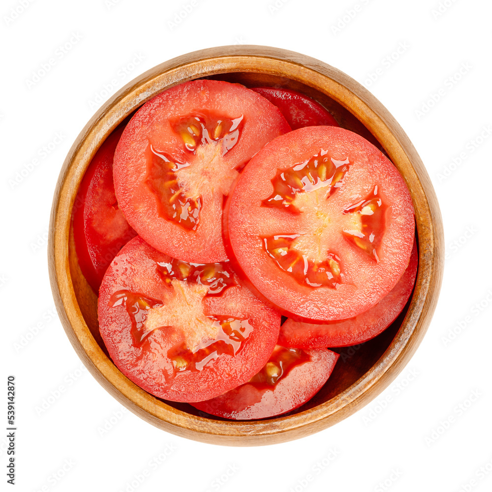 Wall mural Fresh plum tomato slices, in a wooden bowl, isolated from above. Sliced red ripe oval tomatoes, layered on top of each other. Pile of popular processing or paste tomatoes, with cylindrical shape.