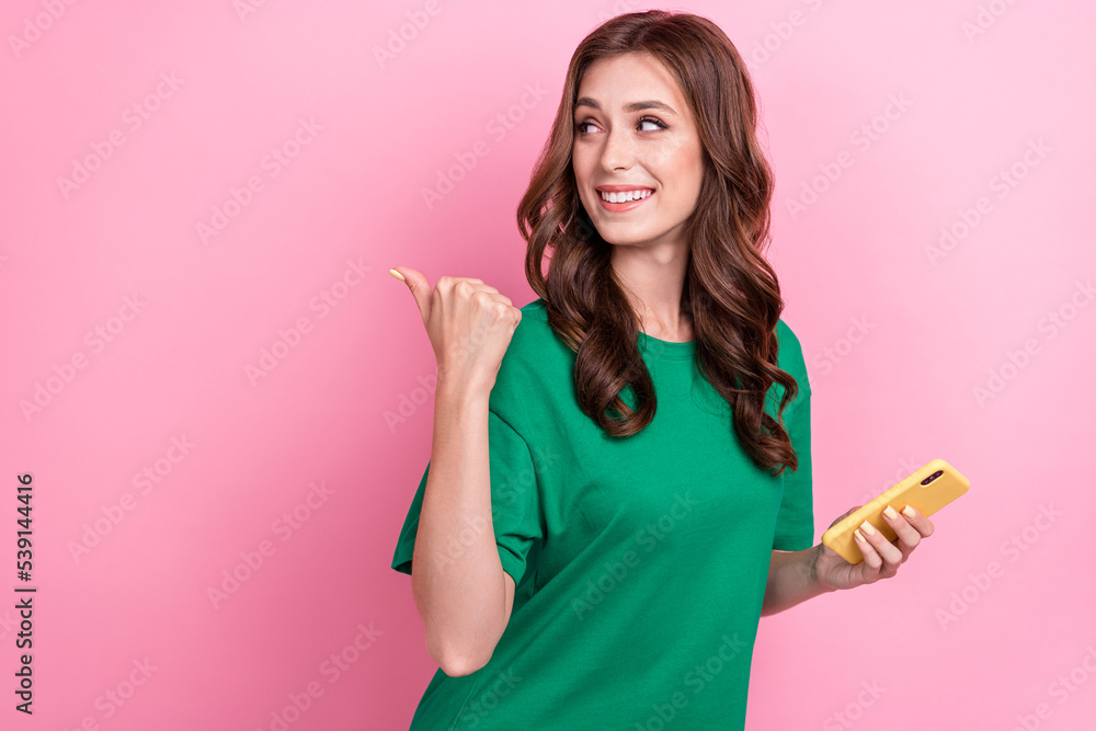 Canvas Prints Photo of cute pretty lovely girl with wavy hairdo dressed green t-shirt directing look empty space isolated on pink color background