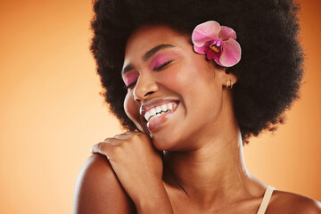Beauty, smile and cosmetic makeup skincare of a black woman with an orchid looking happy. Natural...