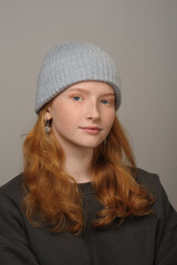young girl model in light blue cap and gray coat isolated on grey background. Product photo mockup for fashion brands and marketplaces.