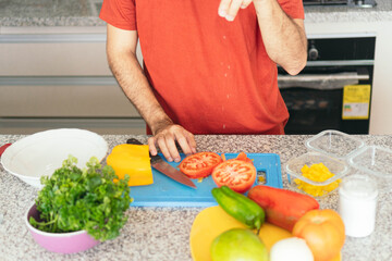 Young Man Making A Salad At Home