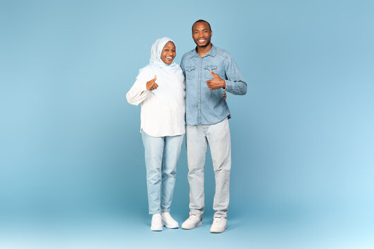 Black Muslim Spouses Gesturing Thumbs Up Standing Over Blue Background
