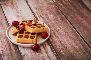 sweet baked Viennese waffles with chocolate filling in a decorative ceramic plate