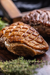 Duck breast perfectly baked until golden brown on cutting board.