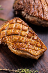 Duck breast perfectly baked until golden brown on cutting board.