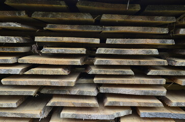 Stack of cut wooden boards at the woodworker workshop