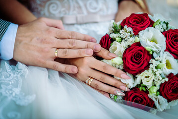 The bride holds a wedding bouquet in her hands, wedding day flowers.