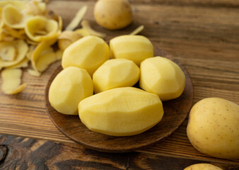 Peeling and Slicing Potatoes on Wooden Cutting Board