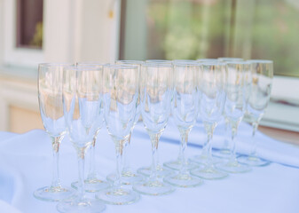many wedding glasses with sparkling wine in restaurant