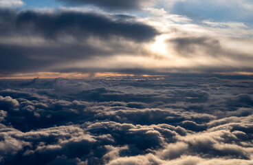 view from the airplane window landscape above the clouds