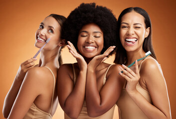 Fototapeta premium Beauty, smile and dental with women and toothbrush for teeth, oral healthcare and hygiene. Orthodontics, lifestyle and diversity with girls against orange background for wellness, clean or dentistry
