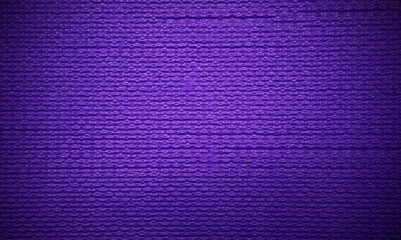 Purple texture of a rubber yoga mat. The background is purple. Soft foam material.