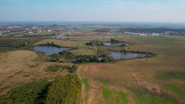 Small bodies of water located in a huge field near the expressway - aerial backward