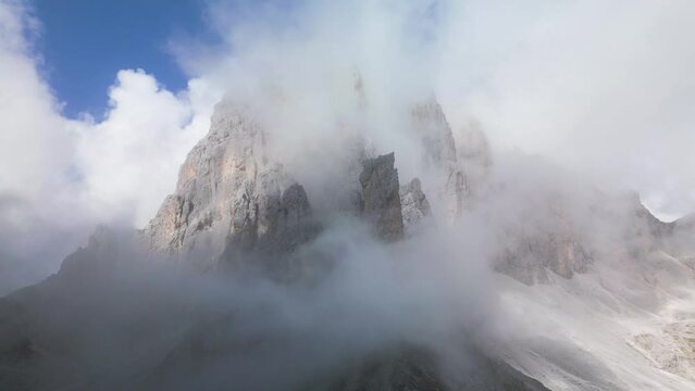 Dolomits, Italy - Pointy Mountain Top Covered in Moving Clouds  - Drone video 4K 50fps colorgraded