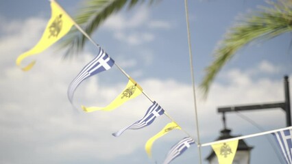 Line am small greek and orthodox yellow flags with double headed eagle on it at the Argonaftis Agios Mamas Church in Spetses