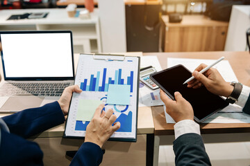 Team business meeting presentation. Hand businessman working project in modern office.Laptop computer and tablet and smart phone on white desk in morning light