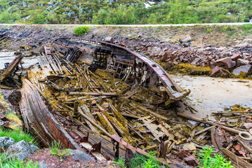 Ship cemetery on the coast of the Barents Sea in Teriberka. Old broken fishing boats in Kola Peninsula, Russia
