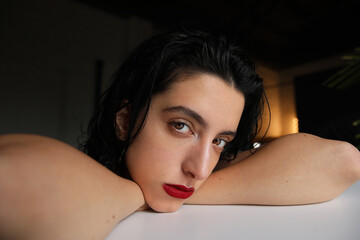 Obraz premium Close-up photo of woman with calm face expression, looking at the camera.