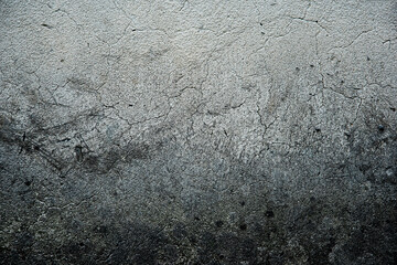 Top view of black, white, gray grunge textured rough stone background with cracks, scratches and stains.