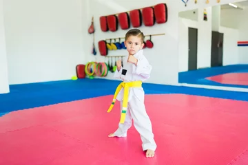 Tuinposter Caucasian kid ready to fight at martial arts school © AntonioDiaz