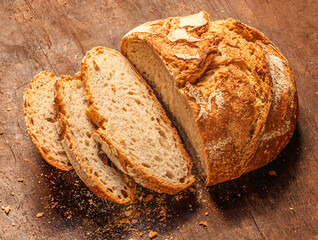Top view of cutted wholegrain bread on dark ructic wooden background closeup. Copyspace. .