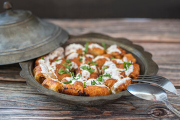 Traditional Bosnian pastry with minced meat (minced meat) in a metal plate. Turkish name; Bosnian dumplings.