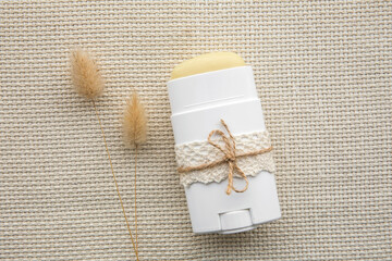 Homemade deodorant stick with all natural ingredients concept. Flat lay view of refill container...