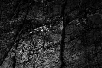 Grungy cragged bumpy pitted cavity stone facade, split layer gap.Ruined cracked shattered worn rough hiking canyon.Old ragged grunge steep marble cliff. Grand vintage crannied damaged impressive gorge