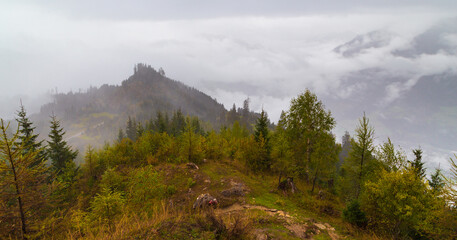 A scenic view of a mountain Hochglocker enveloped in fog in St Johann im Pongau, Austria