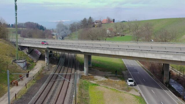 Pacific BR01 01 202 steam locomotive train traveling cross country in Switzerland. It's home-base is in Lyss. A happy site for trainspotters.