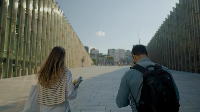 Rear View OF Two Couple Students Walking up Ewha Campus Complex At Sunset, Seoul, South Korea