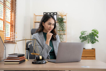 Asian business lawyer woman working with computer laptop in legal office.Law and Legal services...