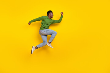 Fototapeta na wymiar Full length body size view of attractive cheerful crazy guy jumping running isolated over bright yellow color background