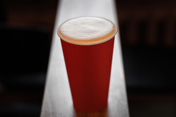 Paper cup of coffee take-away on wooden table. Coffee take away. Cup of coffee to go on the table. Cup of cappuccino