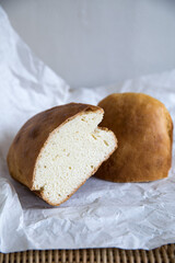 bread loaf sliced, under paper wrap.