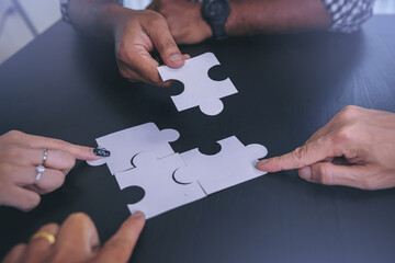 Business peoples putting connect jigsaw puzzle. Team work and strategic solution concept. Selected focus