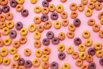 Fototapeta premium children's dry breakfast multicolored rings on a pink background