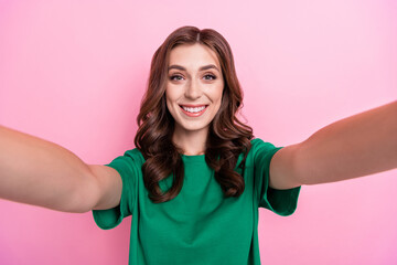 Photo of nice pretty good mood optimistic girl with wavy hairdo dressed green t-shirt making selfie isolated on pink color background