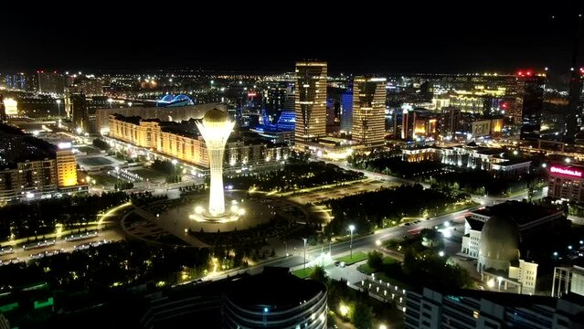Aerial night hyperlapse over Astana (Nur-Sultan) towards iconic Bayterek Tower