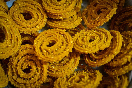 Fresh and Crunchy Chakali. Indian Traditional Snacks For Diwali Festival. Close up of a spiral. Festival of Lights. Diwali Food. Maharshtra Diwali. background with tasty indian chakali rings