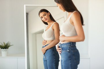 Woman Touching Belly Enjoying First Months Of Pregnancy At Home