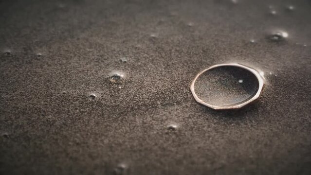 Golden ring on the beach in the sand