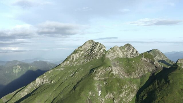 Forward shooting from drone gorgeous natural mountain cliff with gazex summit by sunny landscape clear blue sky. Aerial view adorable rocky peak atmosphere cloudscape cinematic forecast weather. 4k 