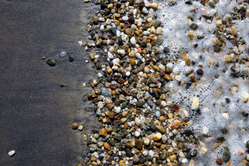 Colorful little stones washed by the shore at a Turkish beach near Çanakkale