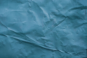 Old blue paint, crumpled sheet of old metal, grungy texture surface, close-up vintage background.